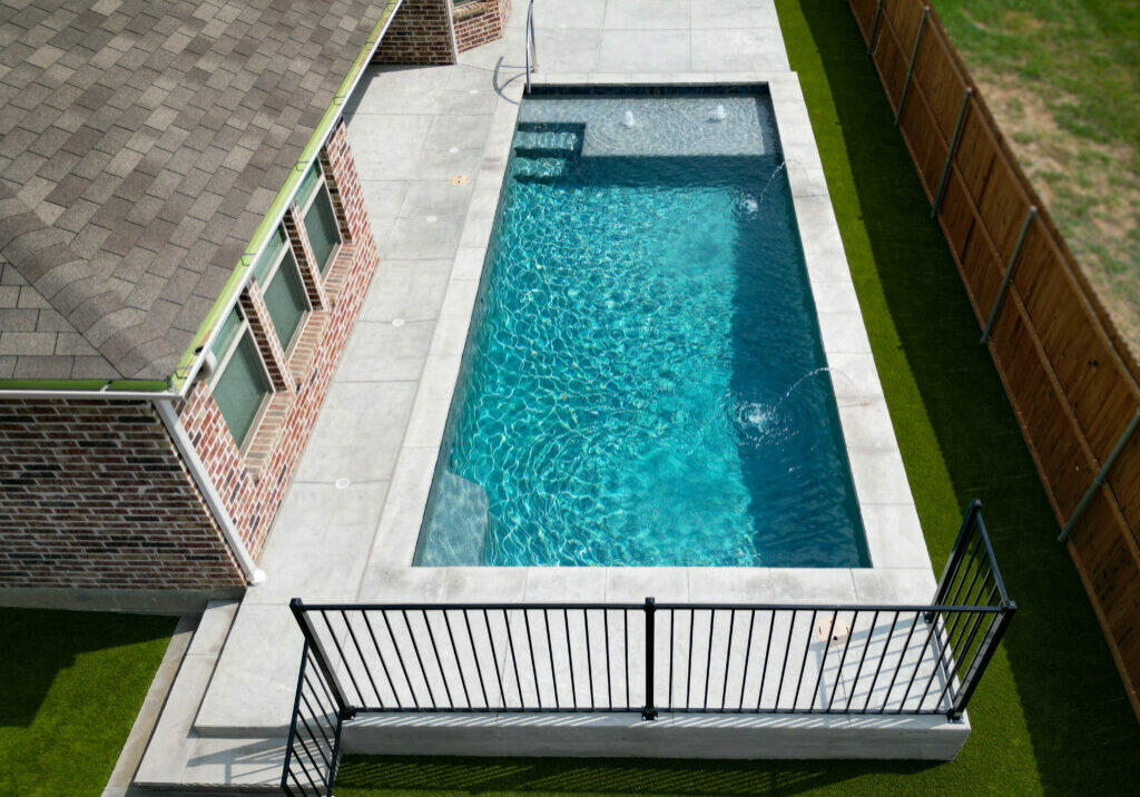 White pool deck surrounding a custom pool